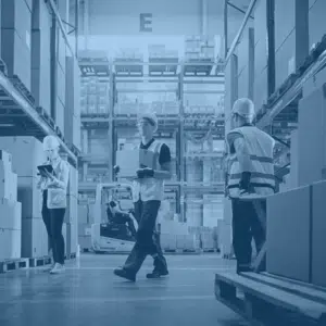 Blue overlayed image of three facilities management workers in a central receiving package warehouse.