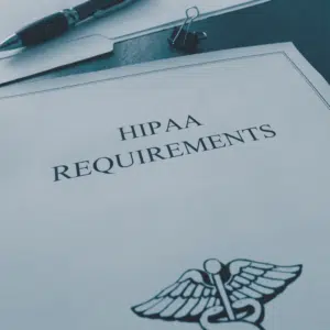 HIPAA requirements document sitting on a desk.