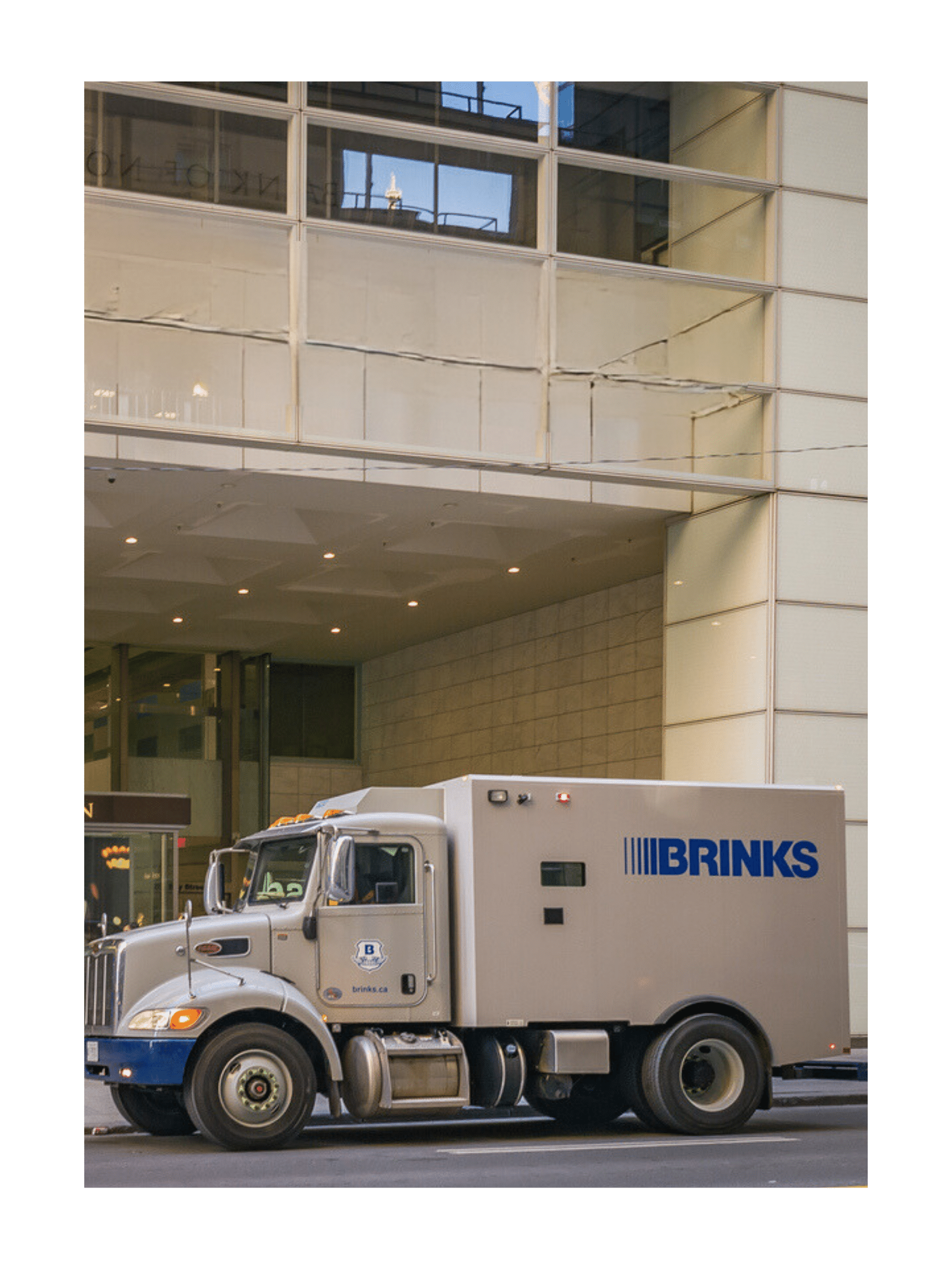 a security truck picking up a branch bag from a bank
